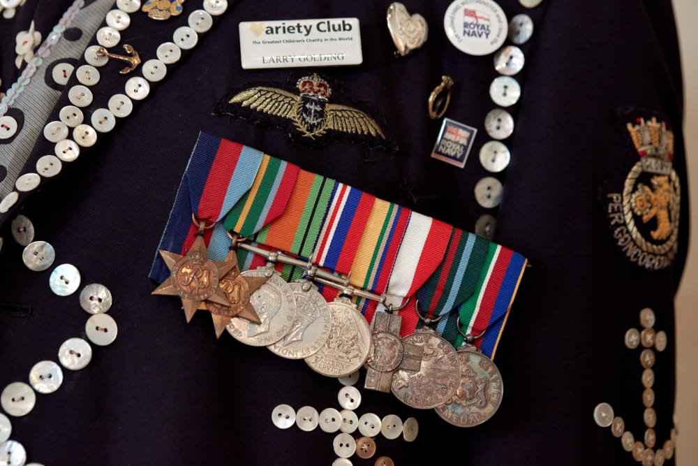 Lots of buttons and pearls sewn onto a jacket