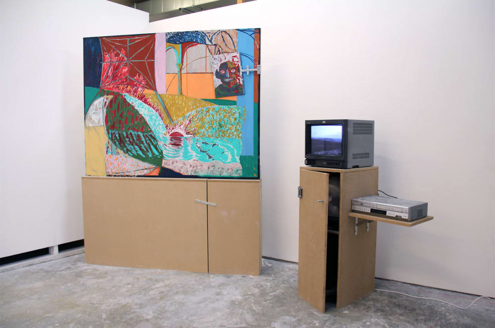 Painting next to television playing film of landscape