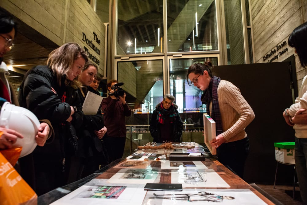 A group of people studying an archive