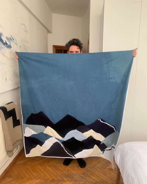 Daniel holding up his finished blanket