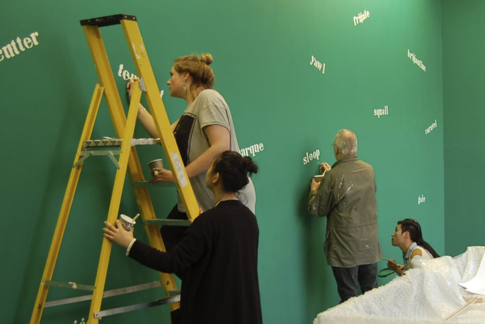 Student setting up an exhibition