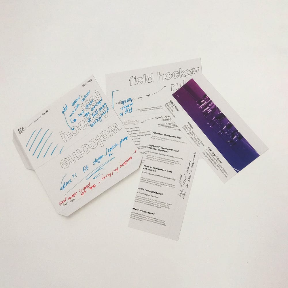 Image shows samples of the leaflets pinned to a wall, they are not yet in colour, but they are written on in pen outlining ideas and where to put the different colours.