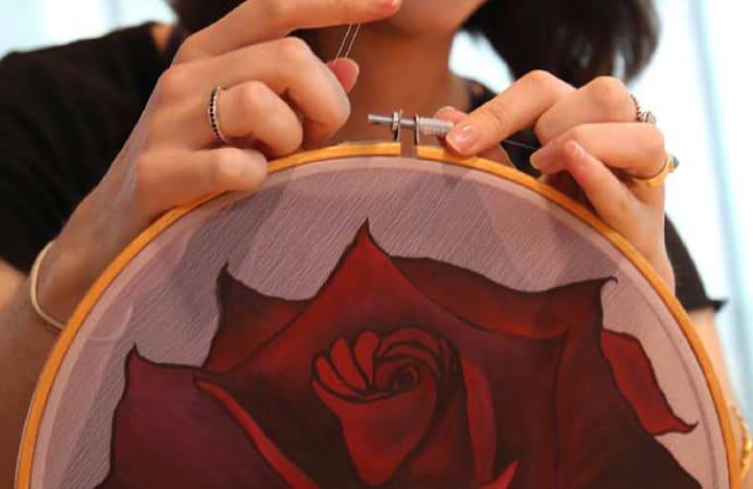 Red rose on embroidery hoop