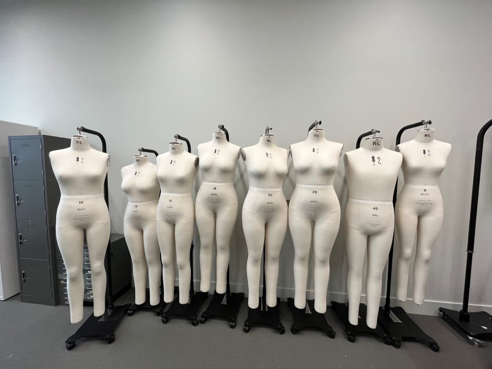 A row of different sized mannequins