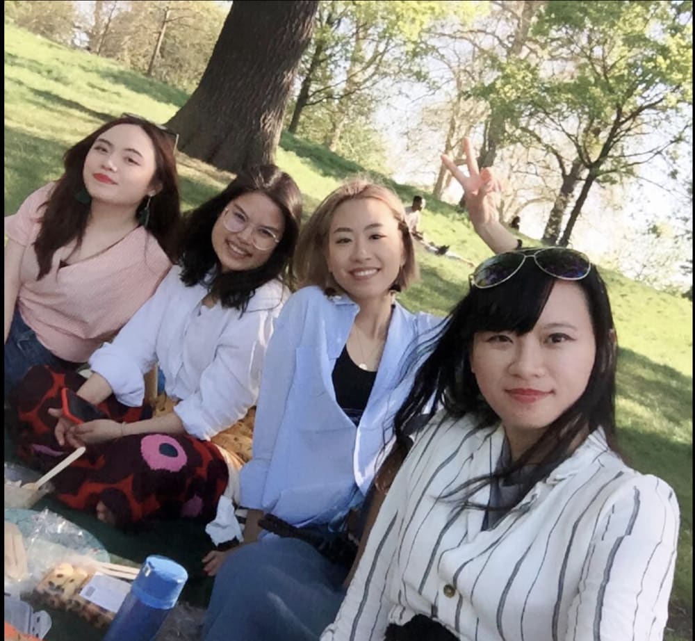 four people in a park having a picnic