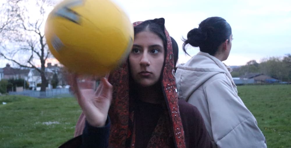 Person spinning football on their finger