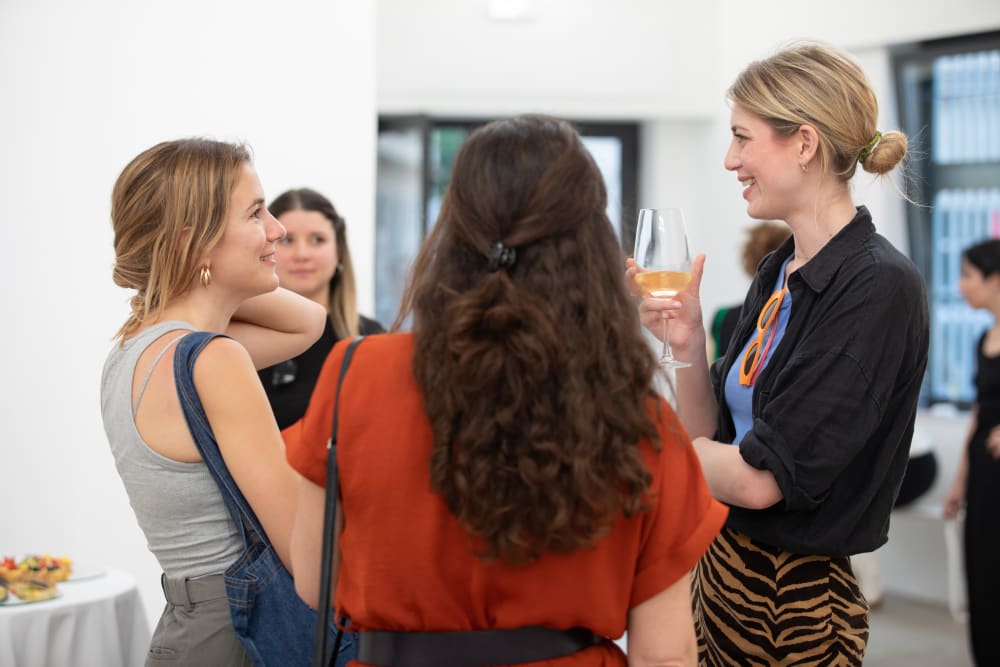 A group of women standing around chatting