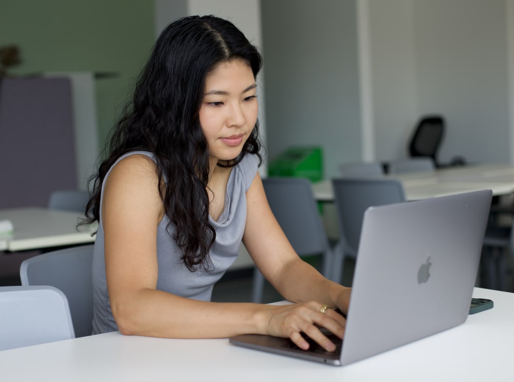 MA Design Management student Maho Irie working on laptop