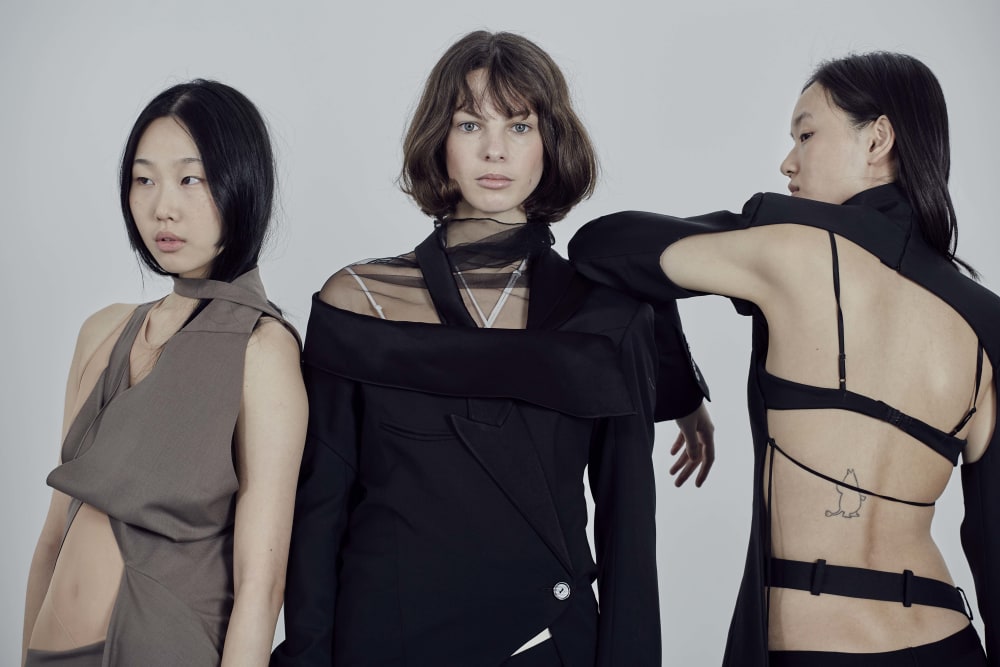 Female models in a curated selection of student designs in black and brown.