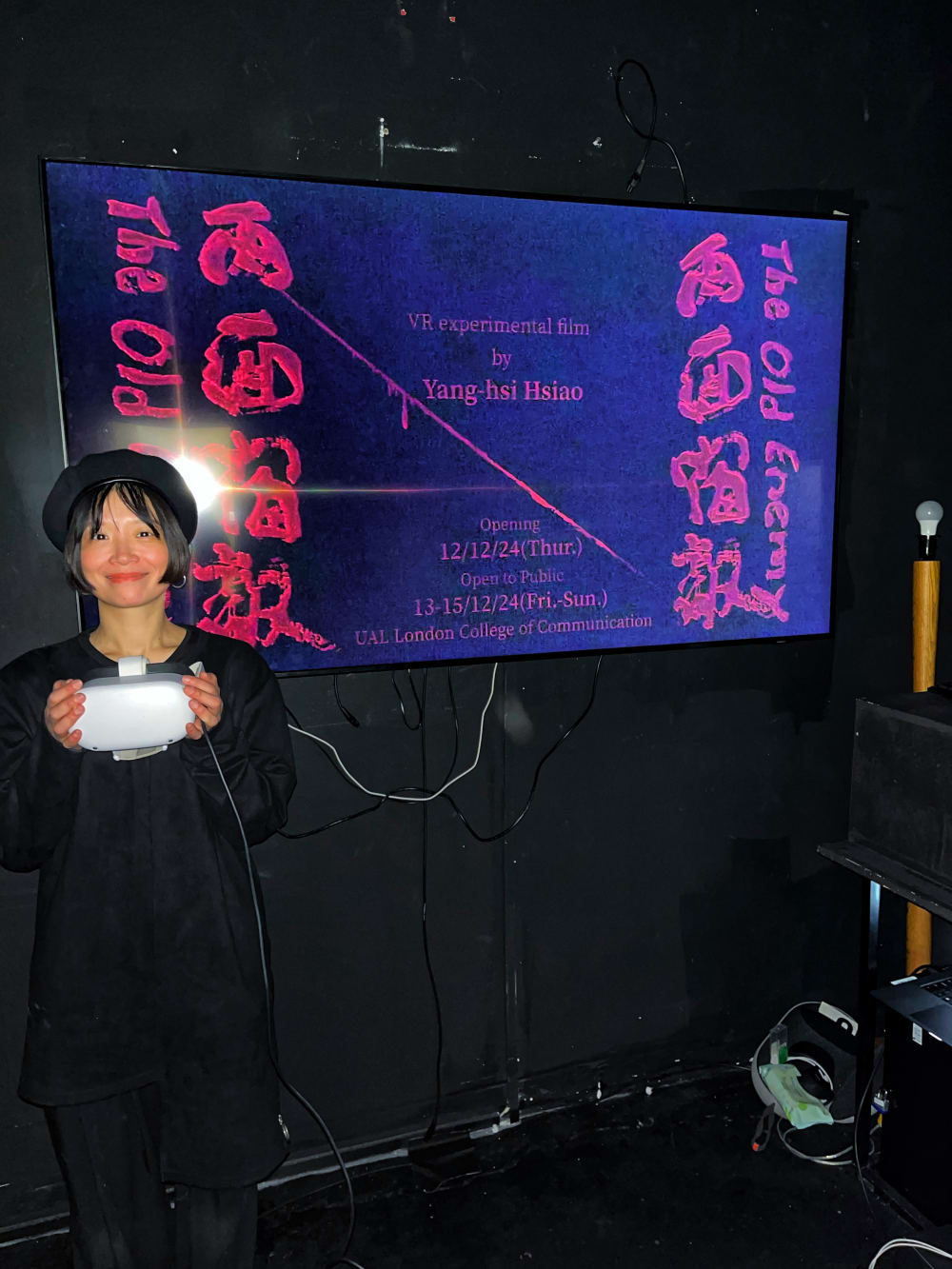 girl standing in front of a pink coloured exhibtbion display