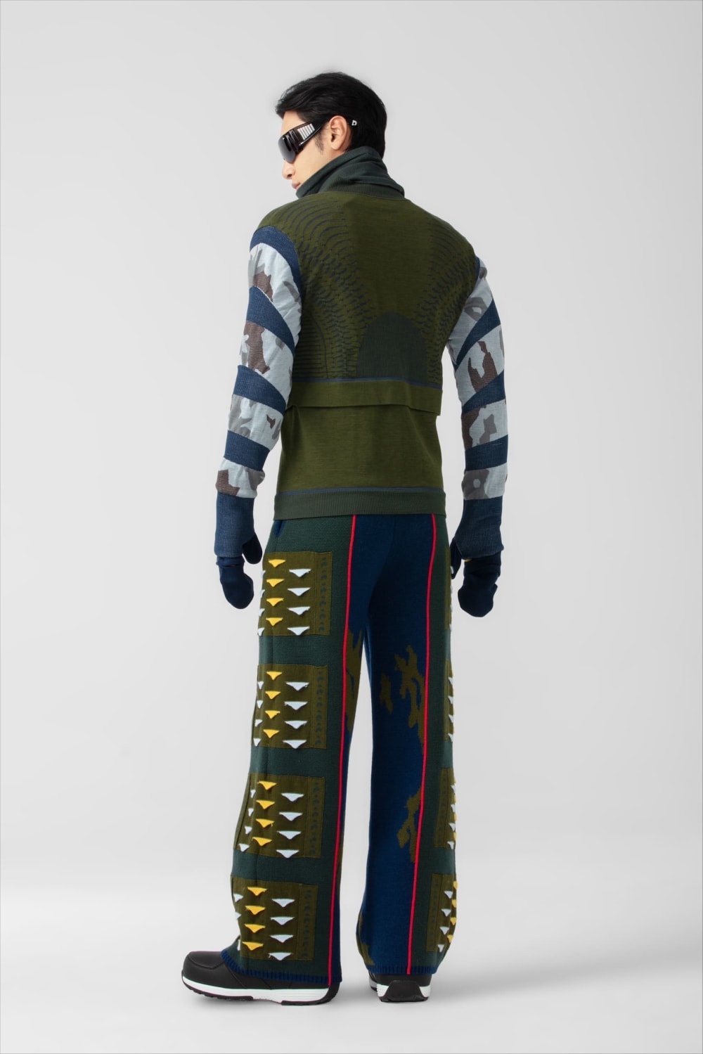 Male model posing in Yingruo's designs facing backwards.