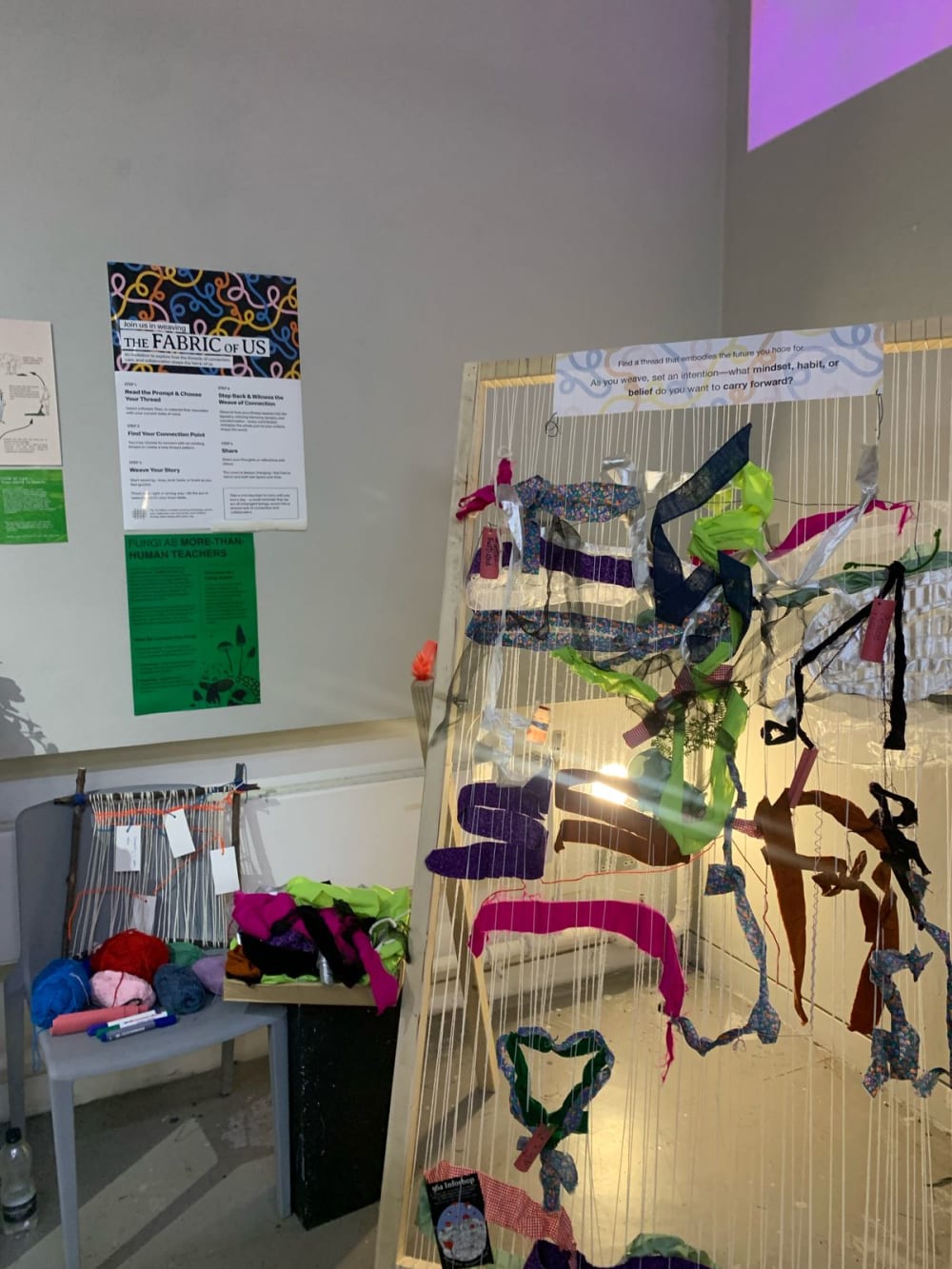 a loom with the beginning of a weaving project