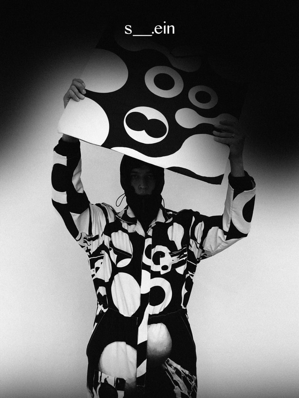 person in monochrome holding canvas