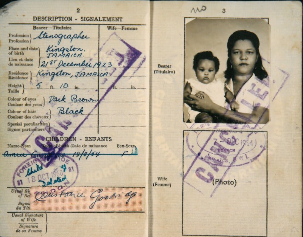 An official document with a photograph of a woman holding a child in her arms.