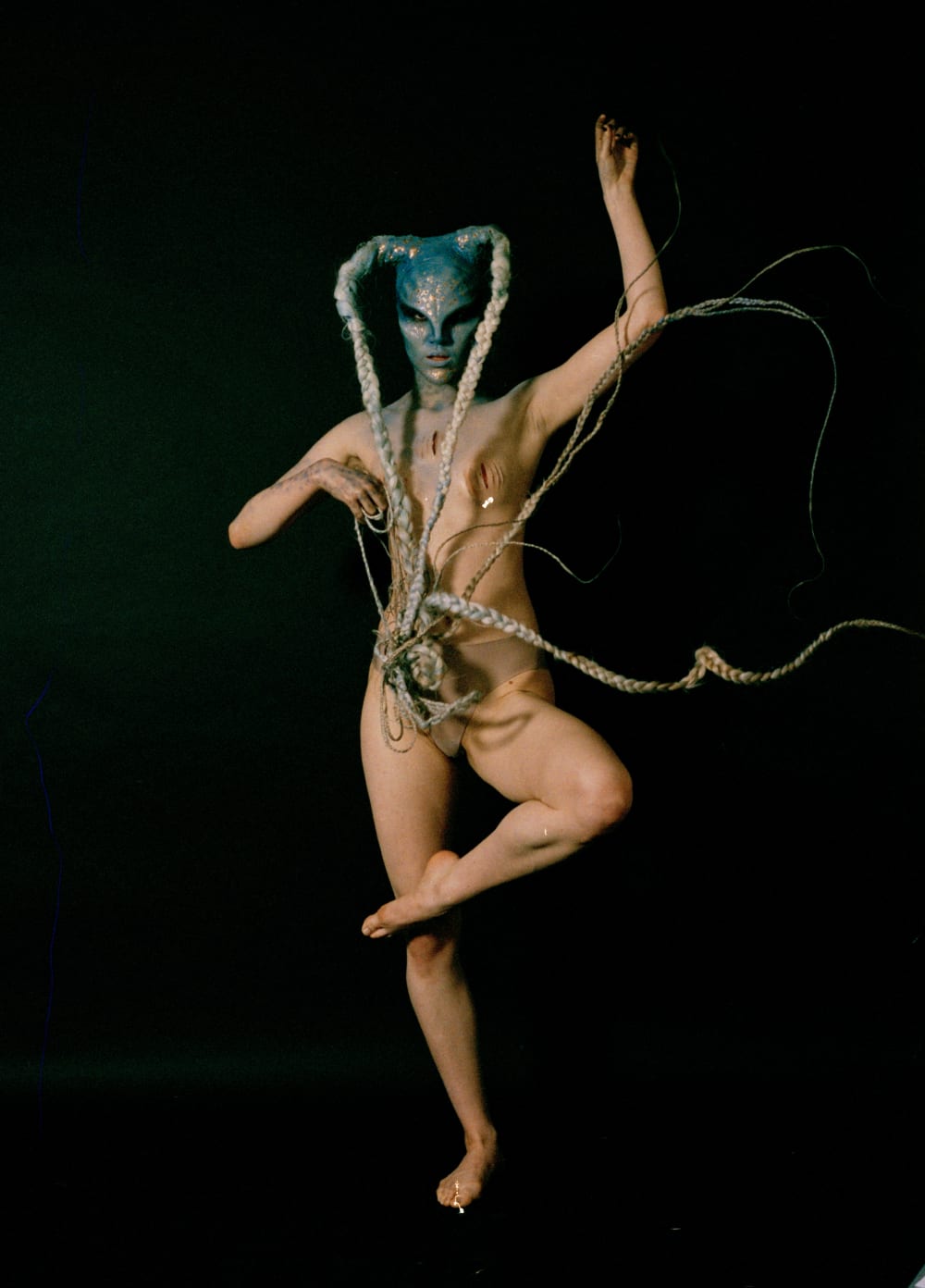 model in prosthetics and blue makeup