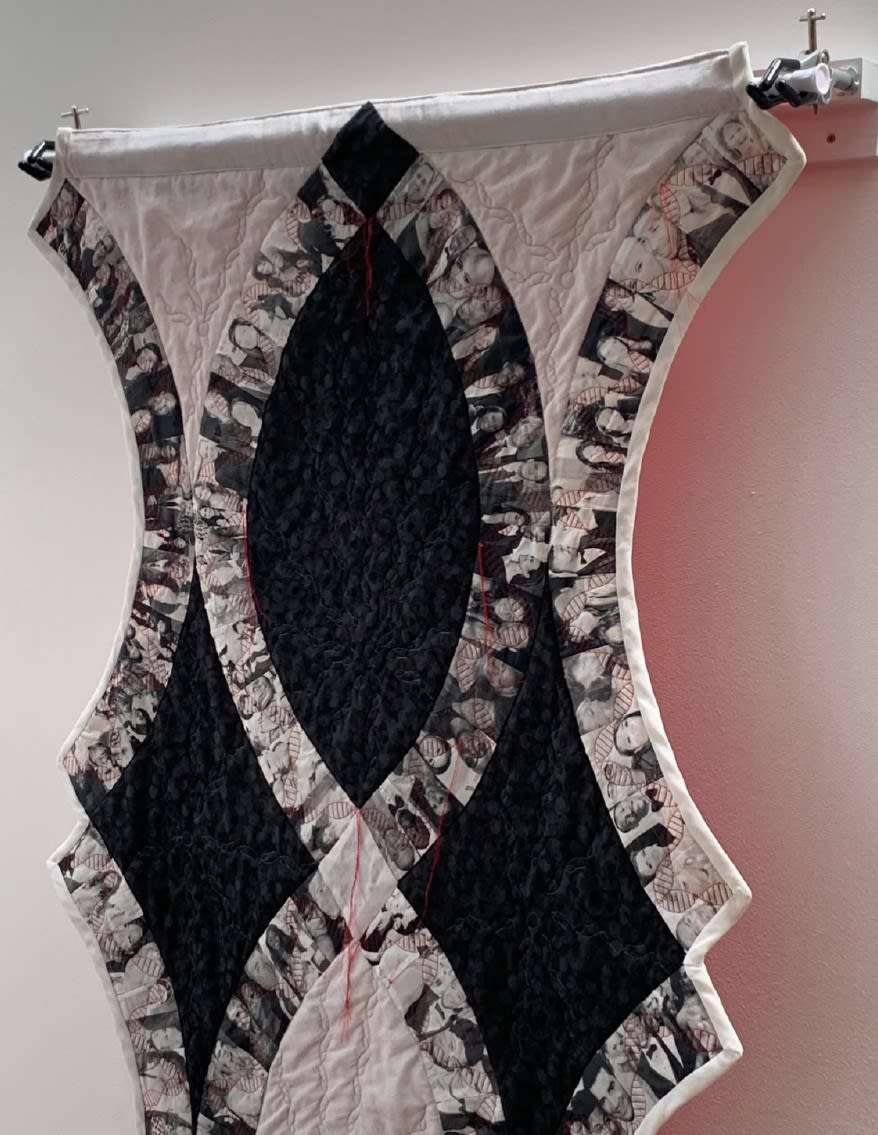 a quilt with portraits of 100 people