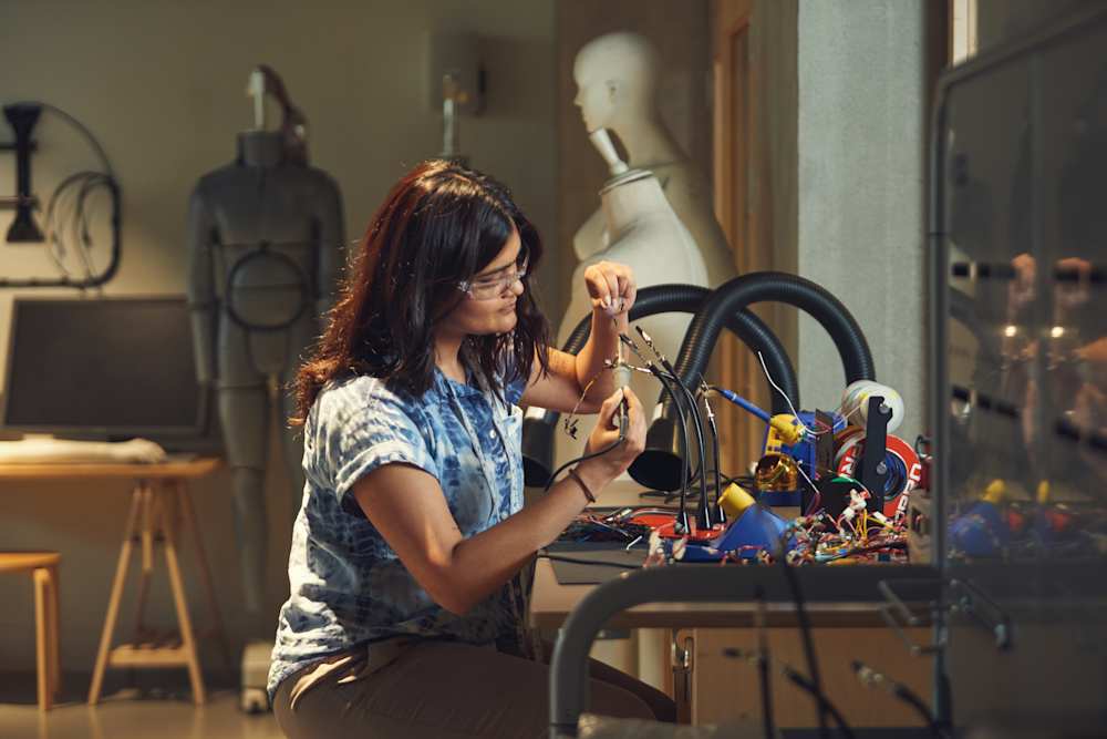 Student working at a desk with a range of electrical equipment