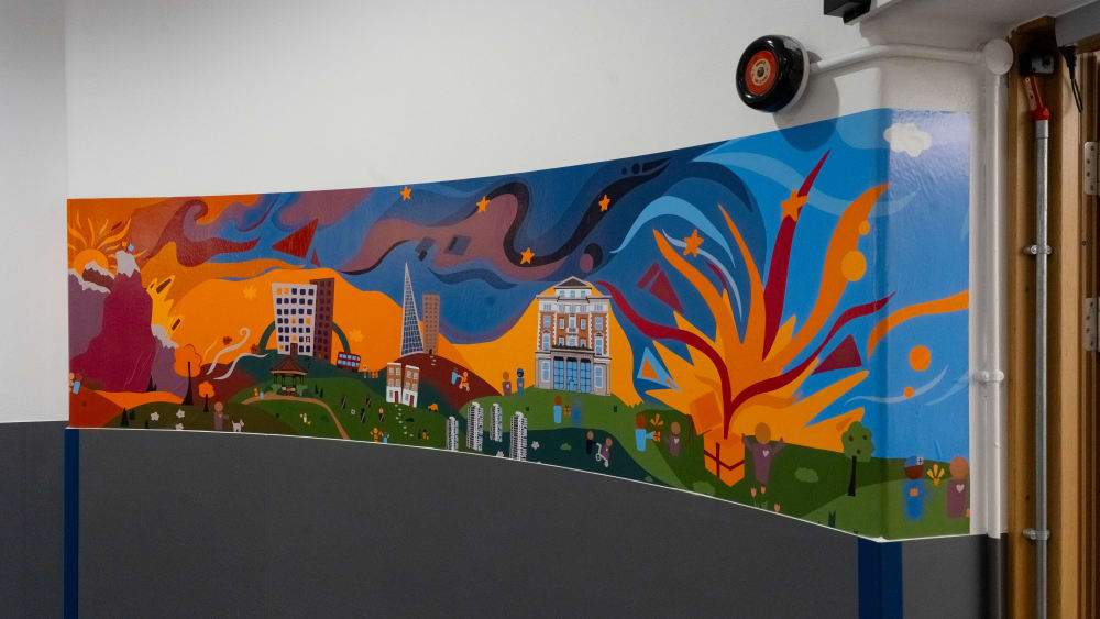 Image shows a colourful mural on a curved wall.