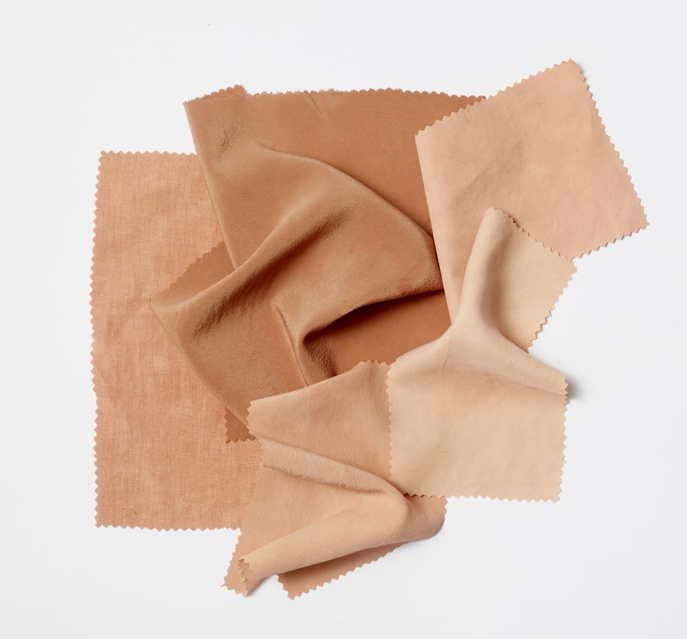 Fabric clippings layered on top of each other in various pink colours dyed by avocados