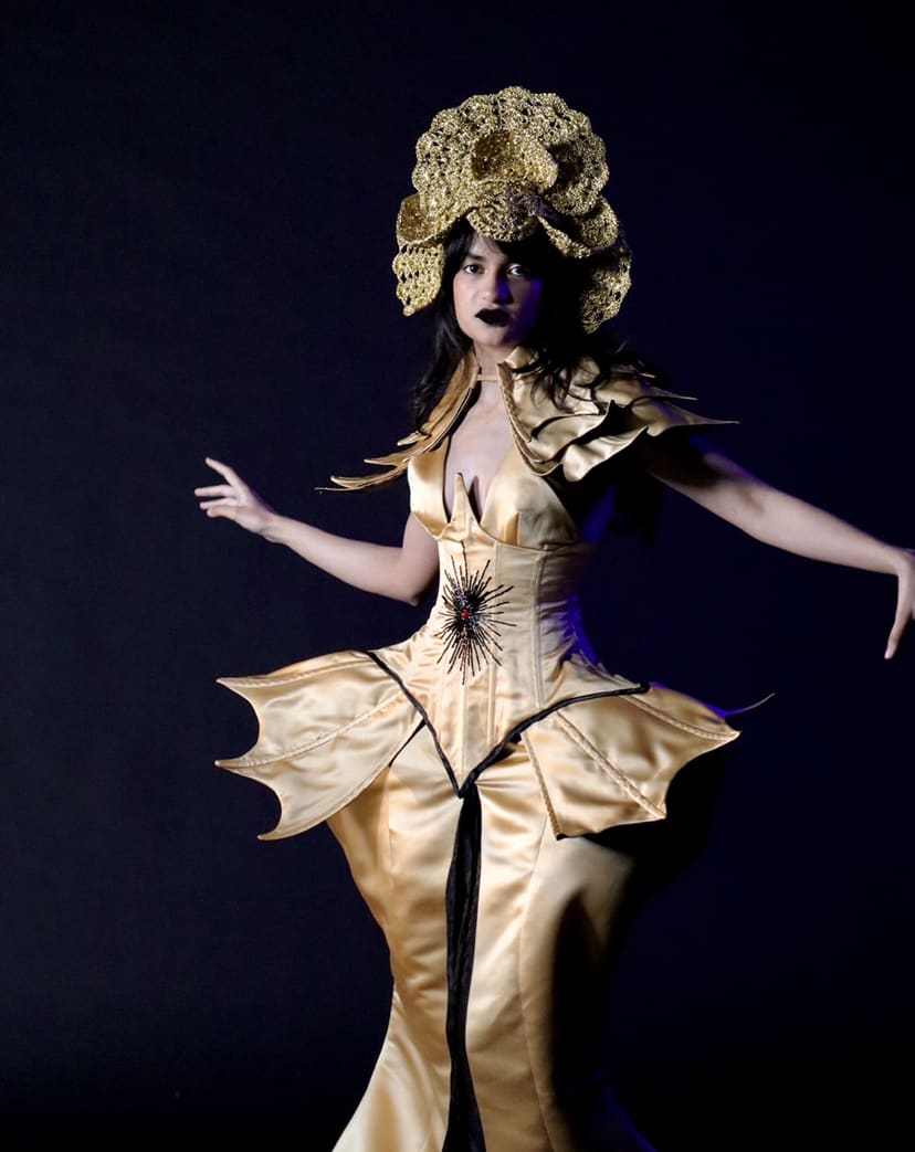 The Mind Costume, model wearing gold costume with gold head piece 