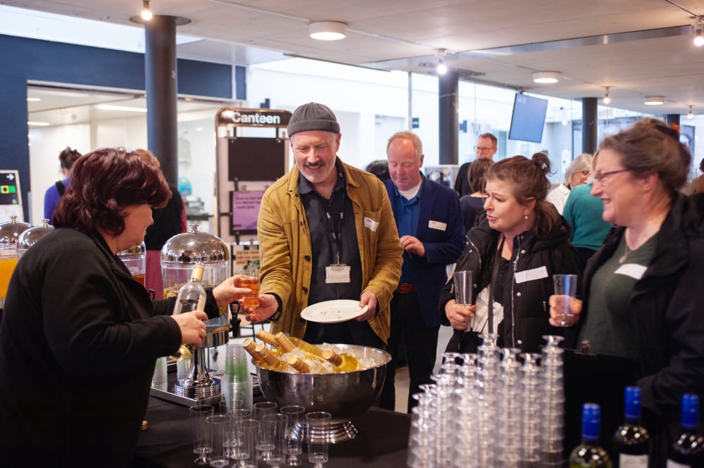 Guests being served drinks and nibbles at the event