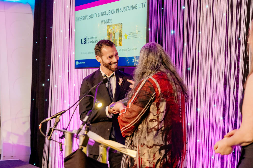 Dr. Francesco Mazzarella being handed the award on stage at the ceremony 