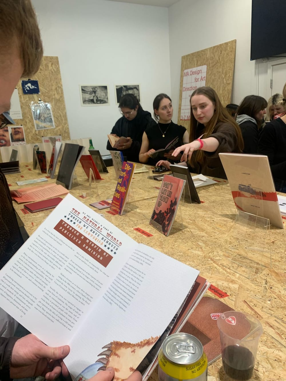a person at a table reading a booklet