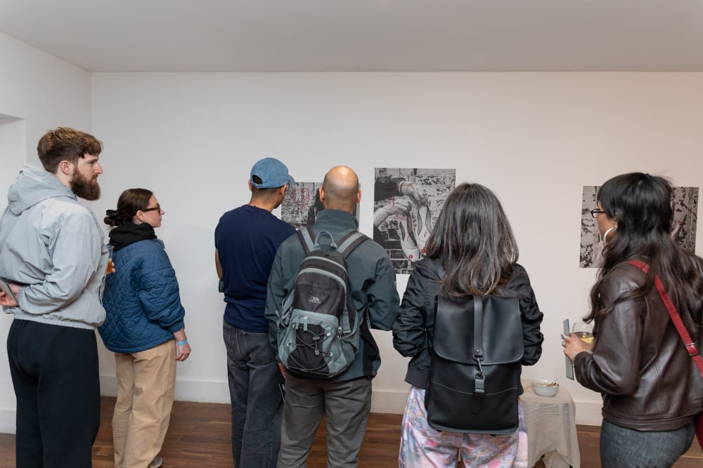 Group of guests looking at work on display