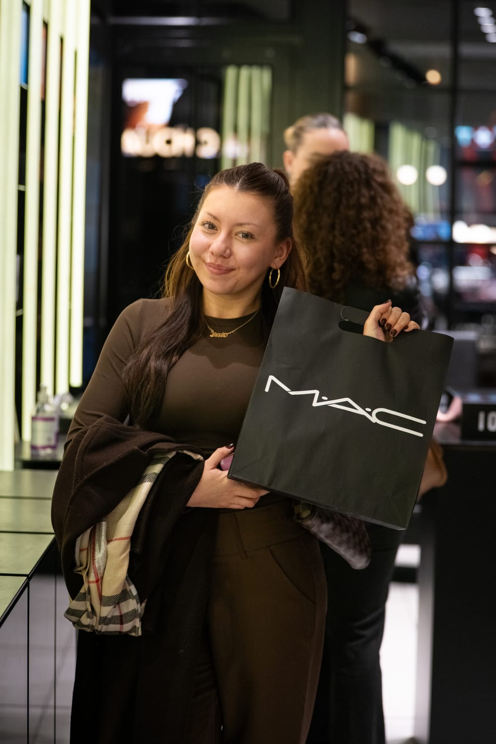a person holding a mac bag