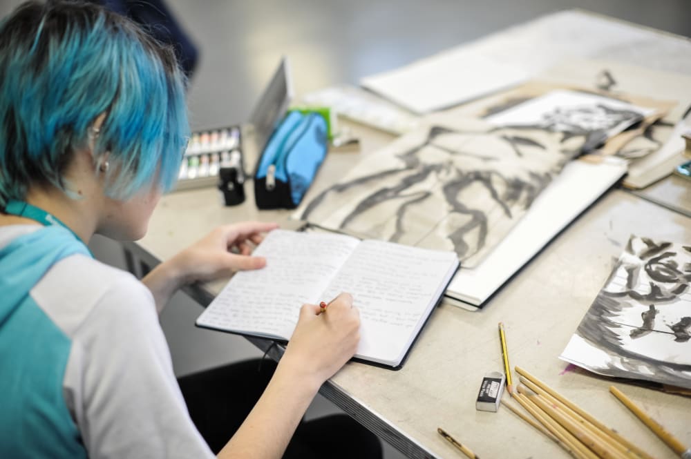 Student writing in a journal