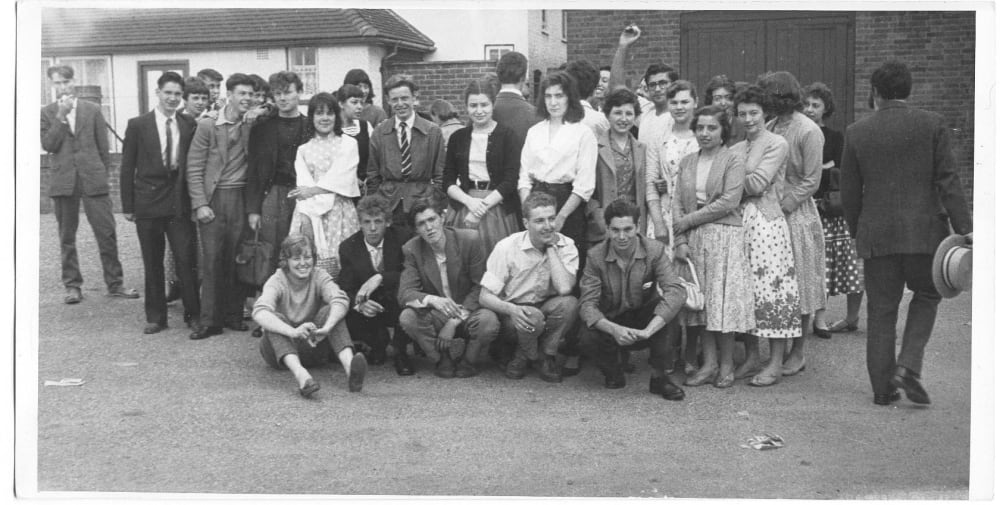 A large group of students looking annoyed at having their picture taken.