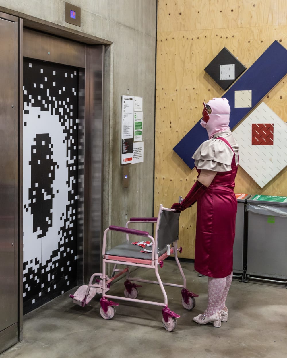 Woman with pink wheelchair waiting for lift
