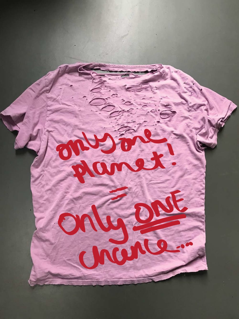 image of well-worn t-shirt with holes in it