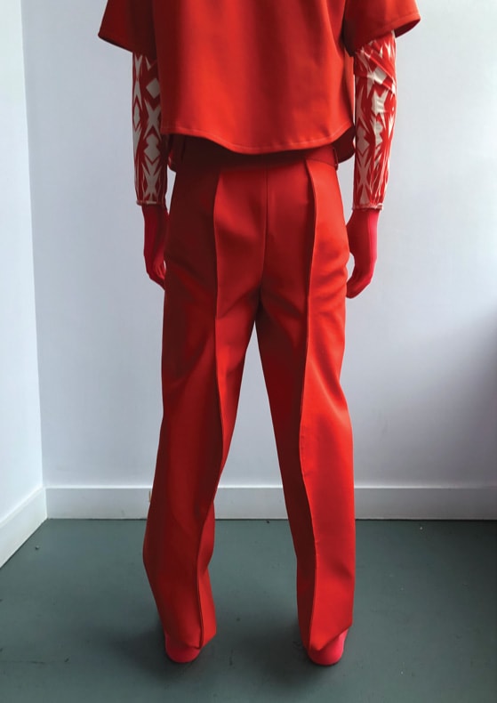 Figure wearing red outfit including full face covering