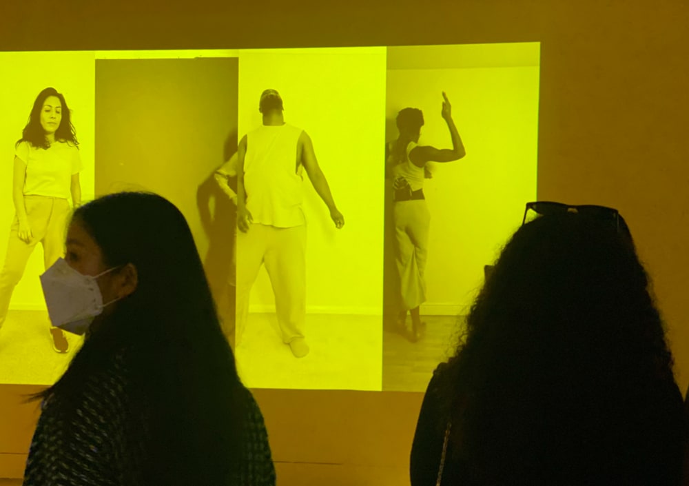 Two people stood in front of a yellow projection