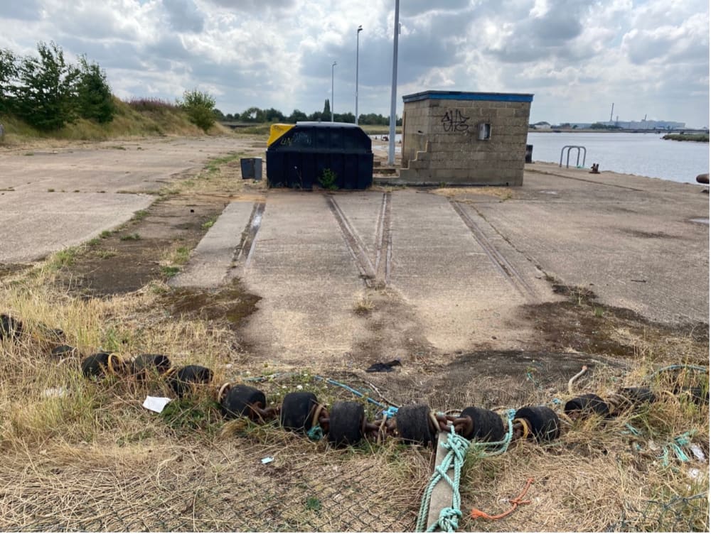 Photo of trainlines next to a harbour