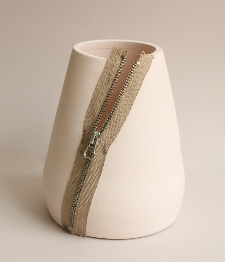 a clay pot with a zip along the side
