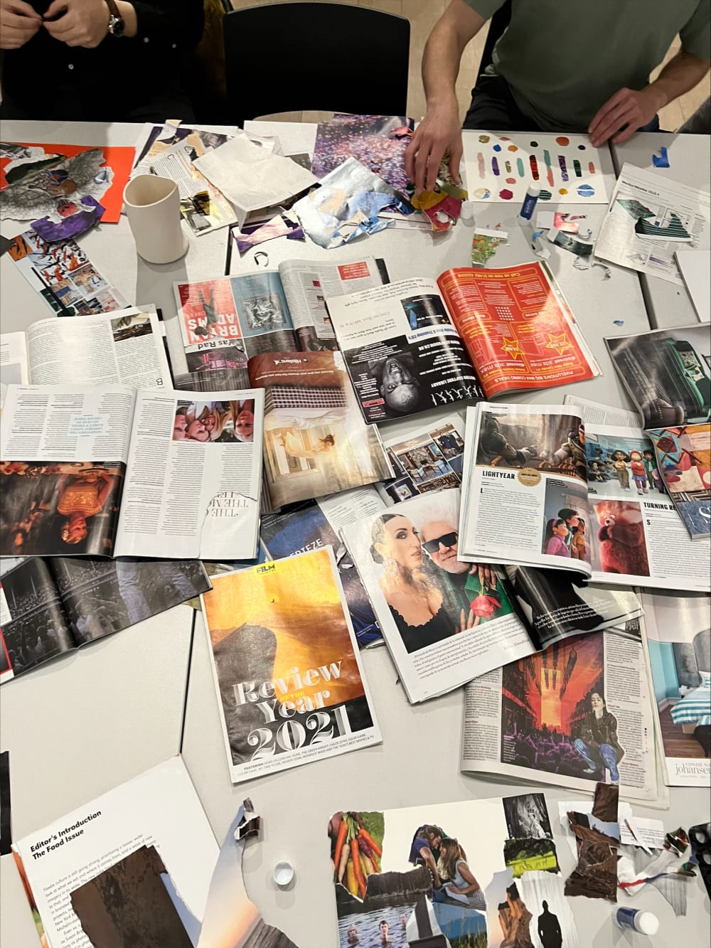 table displaying magazine scraps for collaging activity