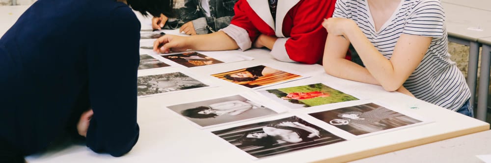 Students gathered around fashion photos
