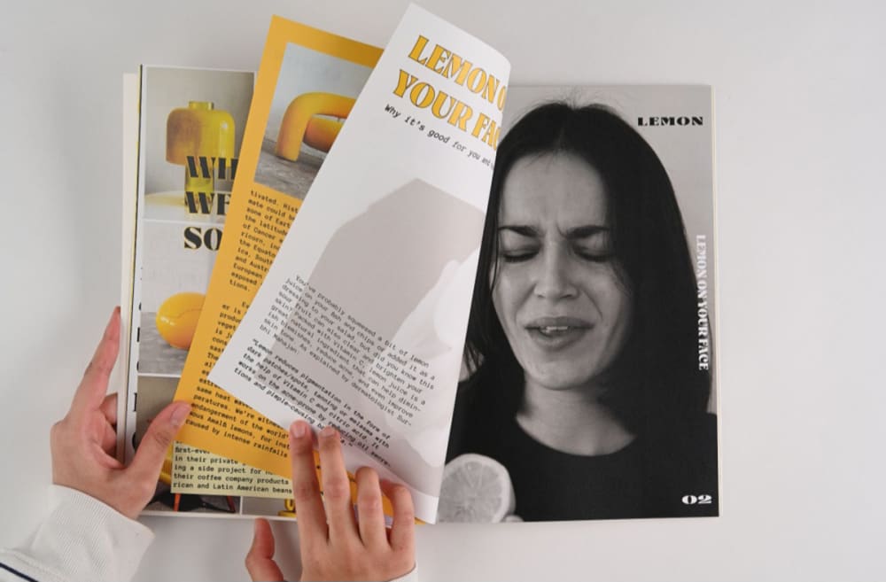 Image of someone reading a magazine with a greyscale portrait inside.