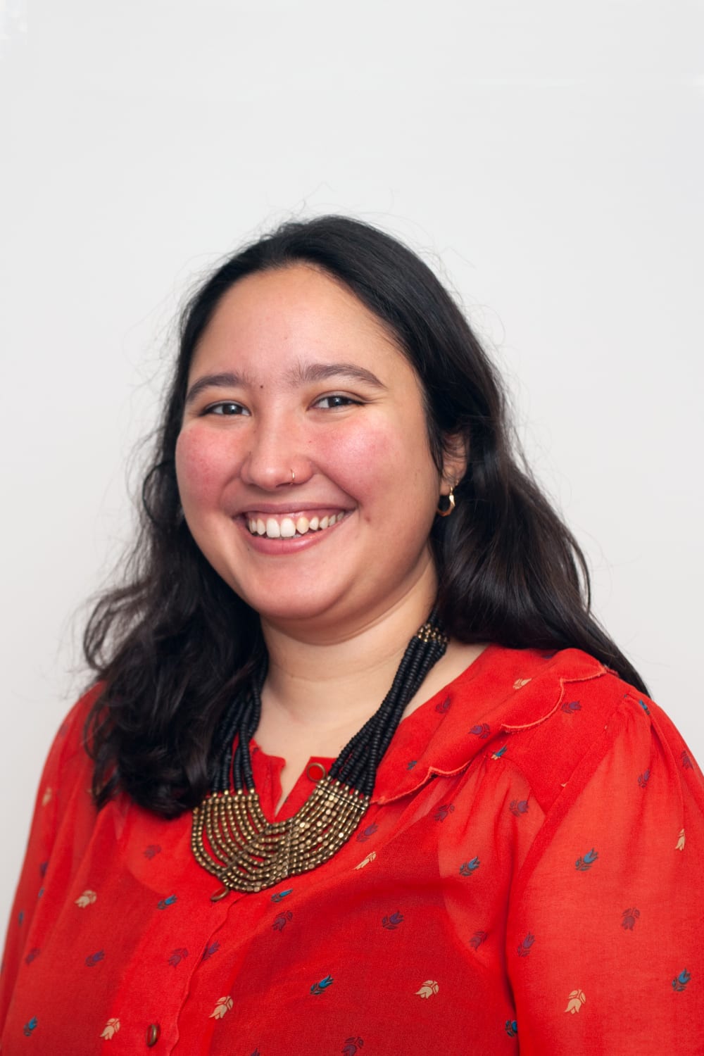 Headshot of Annette, smiling. She's wearing a red jumper.