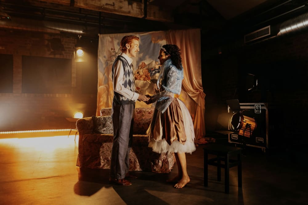 Man and woman facing each other holding hands