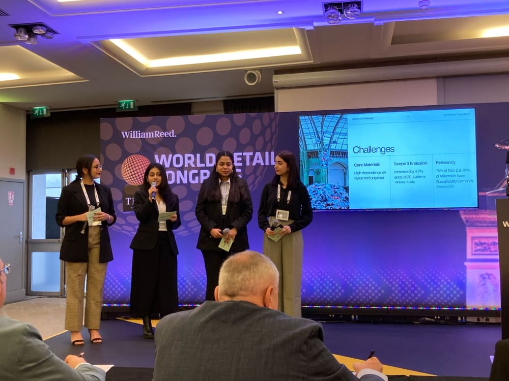 Four students speaking on stage