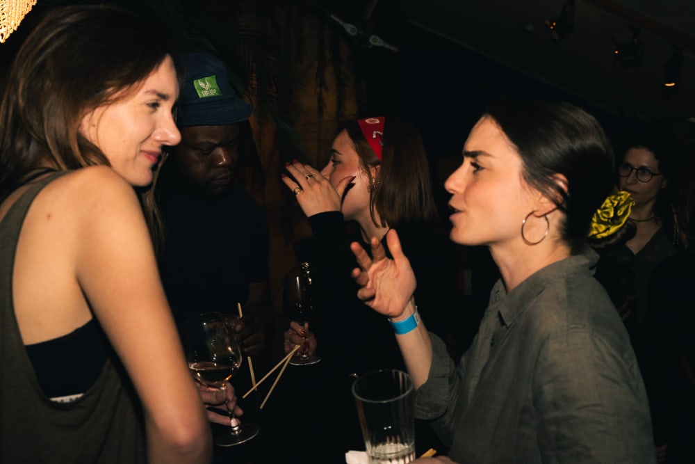 2 guests chatting in a crowded room