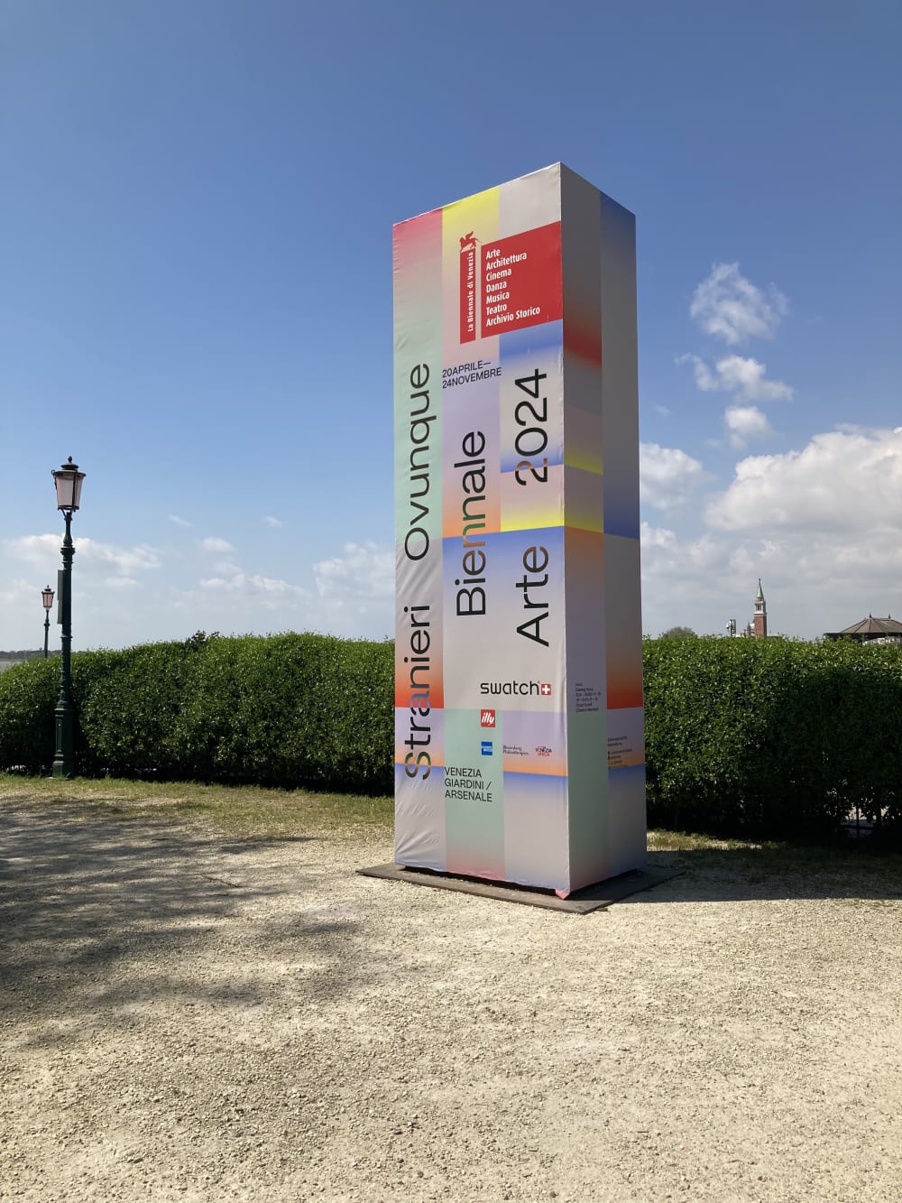 a large tower block draped in advertising for the Venice Biennale