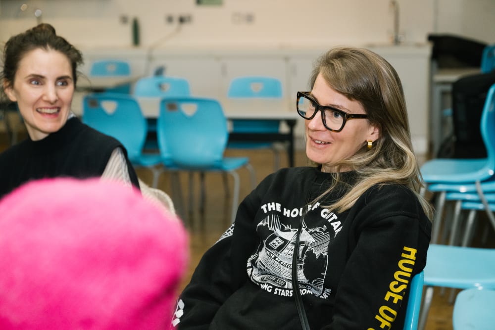 2 guests sat smiling