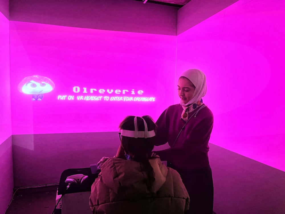 girl putting a VR headset on a visitor