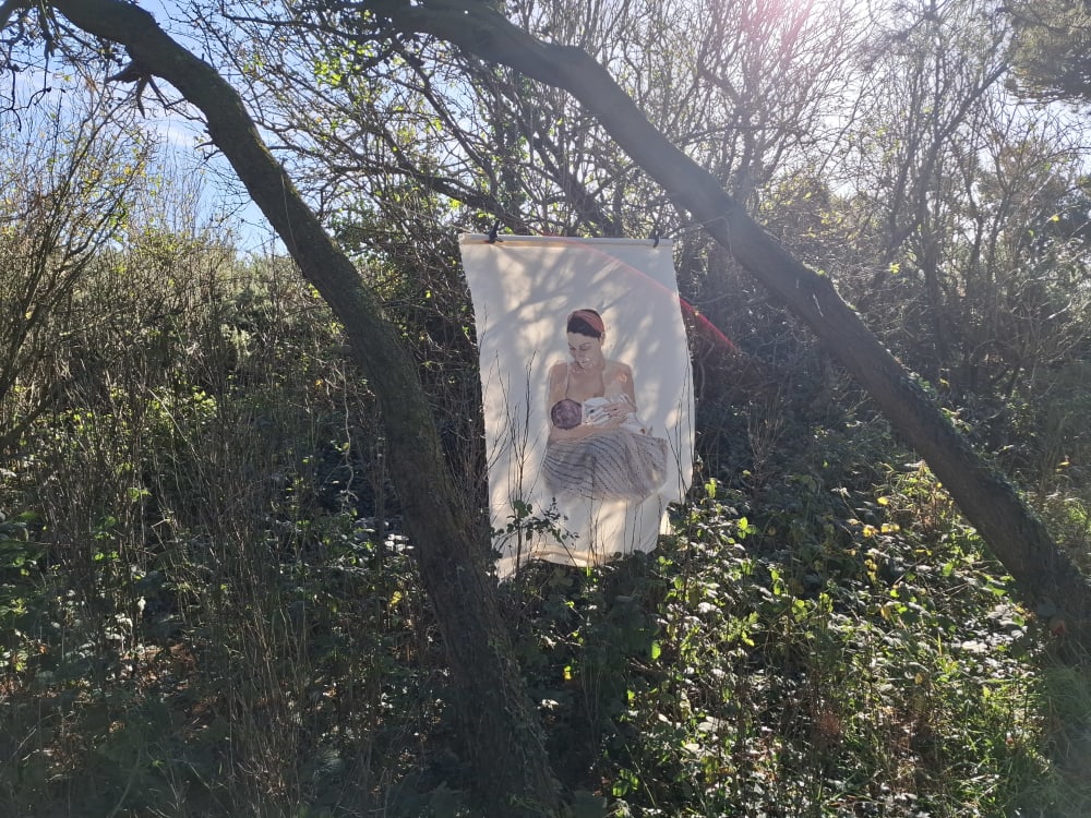 Fabric painting hanging from a tree