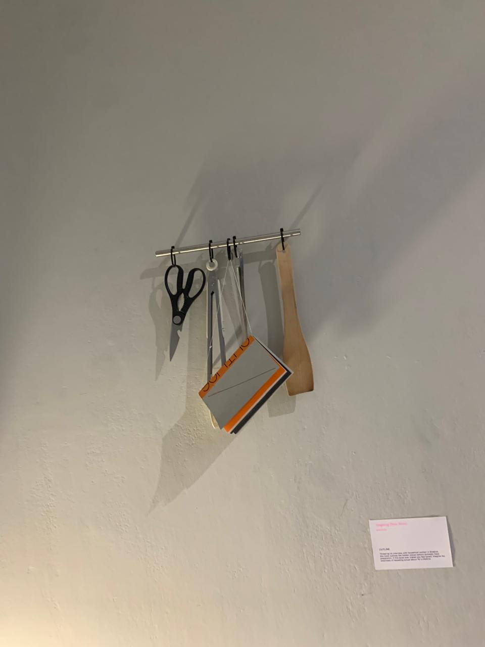 Keychain like art hanged on a white wall