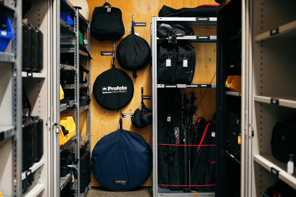 Camera and photography equipment hanging and stacked on shelves in the store